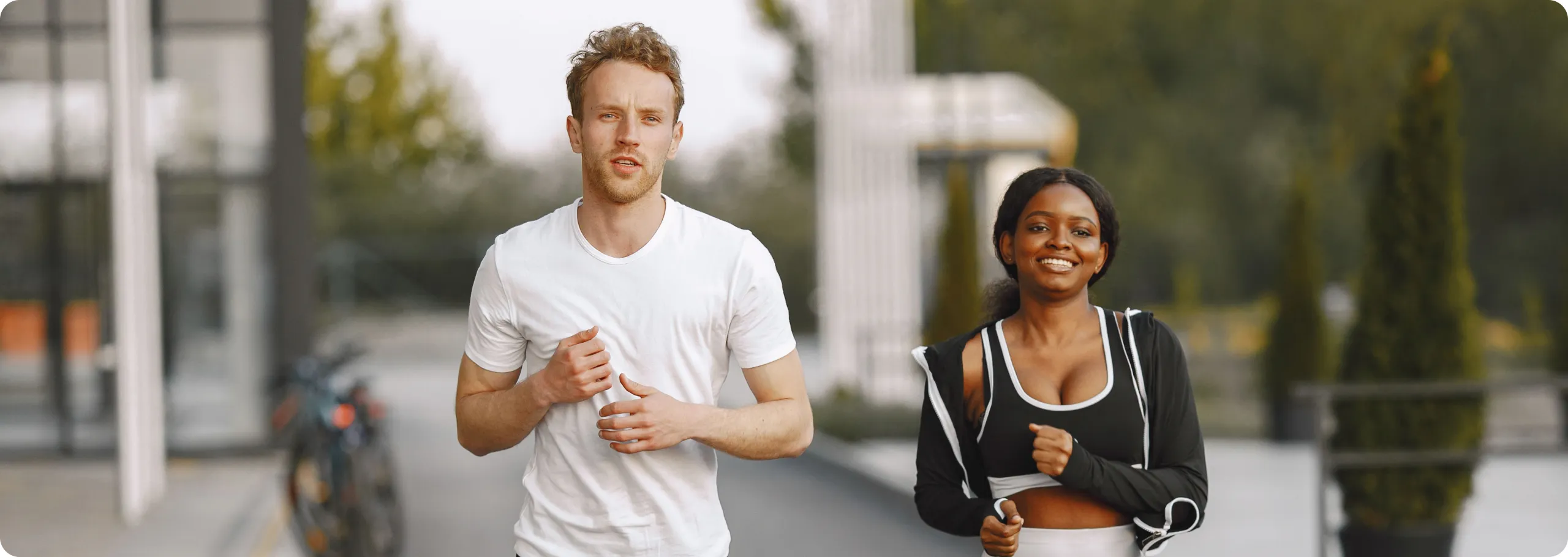 Man and woman jogging together in the city